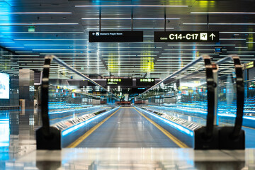 Modern Airport Moving Walkway with Illuminated Glass Railings, Efficient Terminal Conveyor System Featuring Sleek Blue-Lit Design