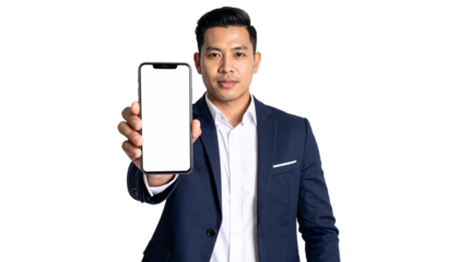 A businessman holding a smartphone in a suit