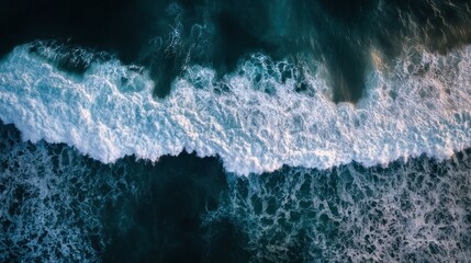 Ocean's Embrace: An aerial view of ocean's cresting waves and churning foam, with deep blue depths, illustrating the raw power and tranquility of the sea.