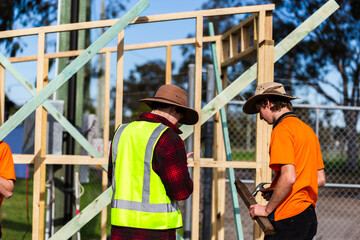 young aussie tradie apprentices working on building frame small project