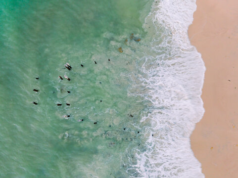 Aerial view of waves washing around derelict wooden pylons at Port Willunga in South Australia