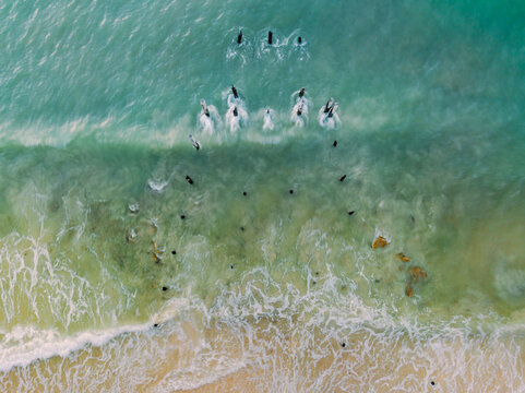 Aerial view of waves washing around derelict wooden pylons at Port Willunga in South Australia