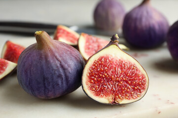 Whole and cut figs on light table, closeup