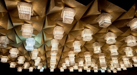 Modern pendant lights. Identical lights on the ceiling of the theater. beautiful ceiling lamp with light bulb, beautiful ceiling decoration with chandelier