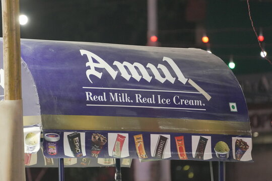 INDIA, DELHI - SEPTEMBER 16, 2025: Amul Ice Cream Stall at Night Fair with Branding Signage
