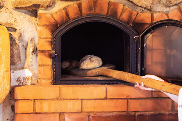 Baking rye bread in a rustic oven, close-up