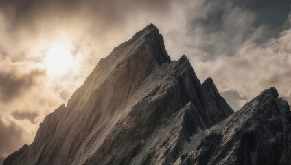 Dramatic Mountain Peaks Bathed in Golden Sunlight Under a Cloudy Sky.