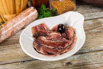 Canned anchovy with oil in the bowl