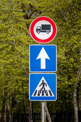European No Trucks Sign with Straight Ahead Arrow and Pedestrian Crossing
