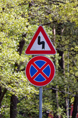 European Road Signs Indicating Winding Road to the Left and No Stopping Zone