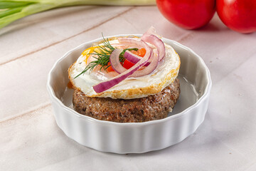 Beefsteak chop with roasted egg