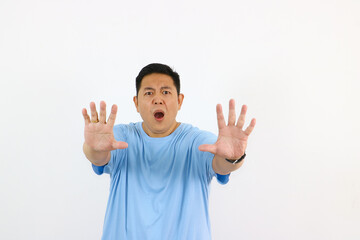 Surprised man gesturing no with hands in front of a white background