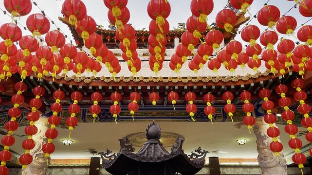 Red lanterns hang over a traditional incense burner at Thean Hou Temple in Kuala Lumpur, Malaysia, symbolizing culture and devotion
