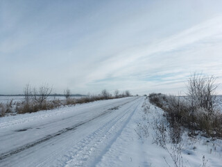 Winter field covered with white snow. Environmental conservation concept. Green eco tourism. Save the planet Earth. Scenic landscape. Rural scene at the countryside. Agricultural cultivation.