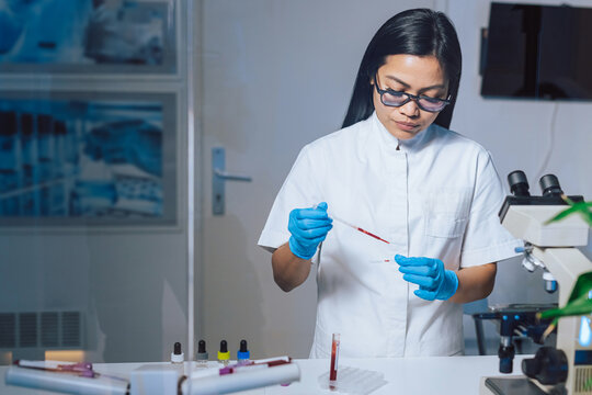 Medical laboratory scientist perform tests on patient samples using a microscope, examining tissue, blood cells, and pathogens.