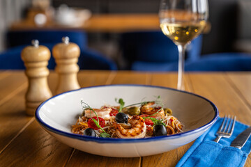 Seafood pasta with shrimp, olives and wine