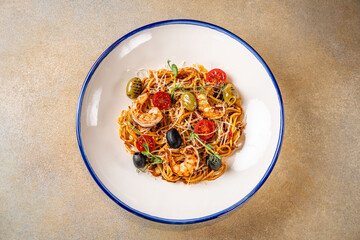 Top view of seafood pasta with shrimp and olives