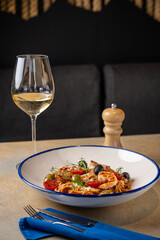 Seafood pasta with white wine in restaurant