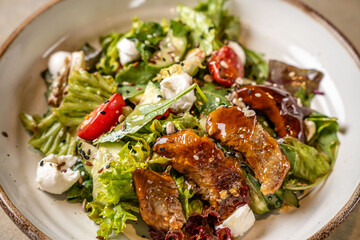 Closeup of fresh salad with smoked eel and sesame