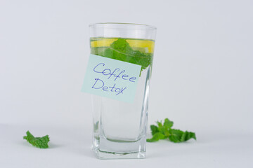 Glass of infused water with a hand written Coffee Detox note