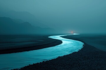 Winding river flowing through foggy mysterious landscape at night