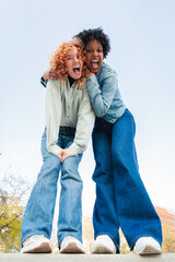 Two exuberant friends sharing a lively and enthusiastic moment filled with joy and laughter,...