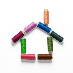 Colorful Thread Spools House with Chimney on Transparent Background