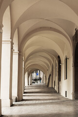 Stone archway corridor with vaulted ceilings, soft natural light, and cobblestone path in an old city. Suitable for architecture, travel, history, and urban design concepts.