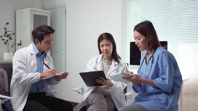 Medical professionals reviewing patient cases and discussing medical records during a hospital meeting