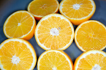 A collection of freshly sliced oranges is resting on a table
