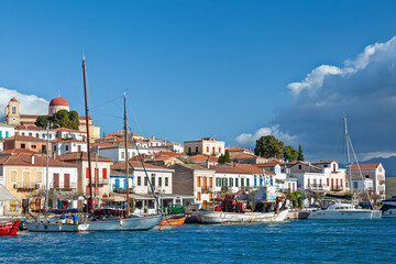 Galaxidi town under tense white clouds, view of the fishing port of this old, traditional village, built by the sea at the Corinthian Gulf, in Greece.
