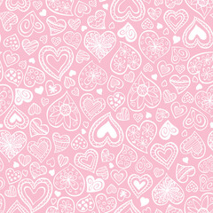 Seamless sketched heart vector pattern. Repeating print with a variety of white hand drawn styled hearts on a pink background. Apparel textile print.