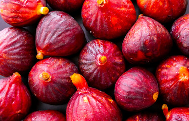 Figs close-up. Heap of figs, whole fruits and cut in half. Sweet exotic fruit for dessert, healthy food.