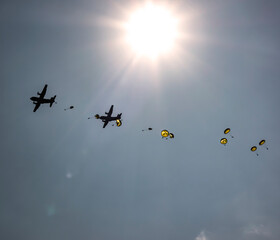 Military paratroopers jumping out of a military plane