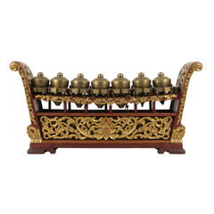 A gamelan instrument features ornate gold painted wood framing seven brass kettle gongs on white or transparent background