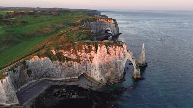 Aerial view of the impressive white cliffs of &Eacute;tretat meeting the blue sea, with the iconic arch standing tall, &Eacute;tretat, Normandy, France.
