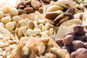 various nuts background, raw food in bowls, top view