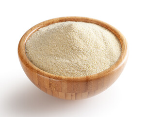 Semolina flour in wooden bowl isolated on white background with clipping path