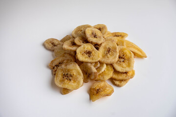 Banana chips on a white background. Dietary sweets.