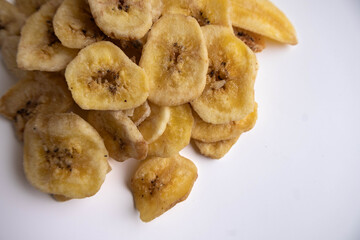 Banana chips on a white background. Dietary sweets.