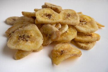Banana chips on a white background. Dietary sweets.