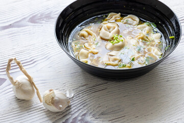 Close-Up of Molo Soup in a Black Bowl – Traditional Filipino Dish
