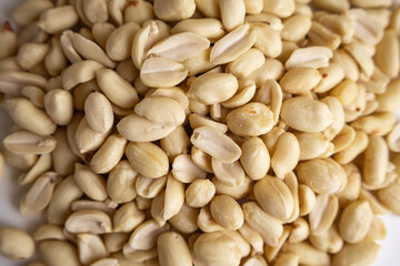 raw shelled peanuts on white background