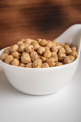raw chickpeas in a bowl on a white background