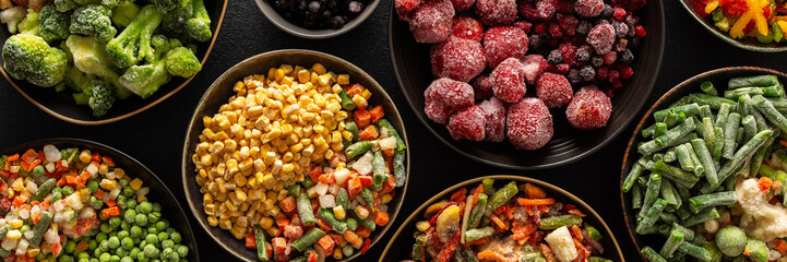 Frozen summer vegetables and fruits in plates, set on a dark background, emphasizing the seasonal preparation for winter storage and future meals, banner