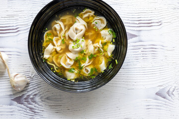 Close-Up of Molo Soup in a Black Bowl – Traditional Filipino Dish
