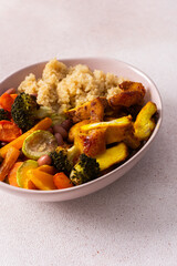 A well-balanced breakfast spread showcasing quinoa, baked sweet potato with carrots, zucchini, broccoli, beans, and baked chicken breast seasoned with turmeric