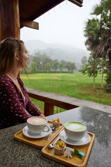 A Serene Moment: Enjoying Refreshing Beverages While Overlooking Lush Green Rice Fields in a Tranquil Atmosphere Surrounded by Nature