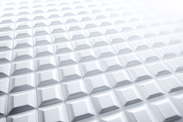 A minimal futuristic pattern of embossed white squares, viewed flat with glowing overexposed tones, shallow 2.5D depth.
