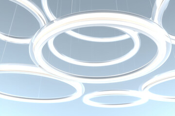 A futuristic minimal white scene with multiple glowing rings floating, background softly blurred.